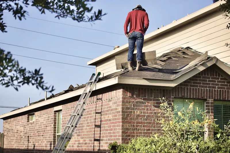 Professional roofer working on a residential roof in Breezy Acres